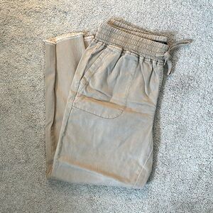 Tan, pants with pockets and flared ends.